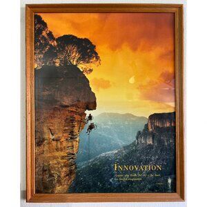 Innovation Art Inspirational poster framed in a wood frame.